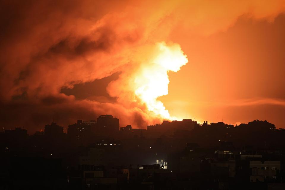 Fire and smoke rise above buildings in Gaza City during an Israeli air strike, on October 13, 2023, as raging battles between Israel and the Hamas movement continue for the sixth consecutive day.