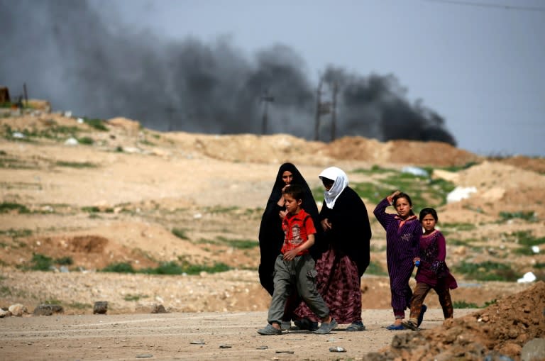 Iraqis fleeing fighting between government forces and the Islamic State group in Mosul's Old City make their way on foot to the Hammam al-Alil camp on March 29, 2017