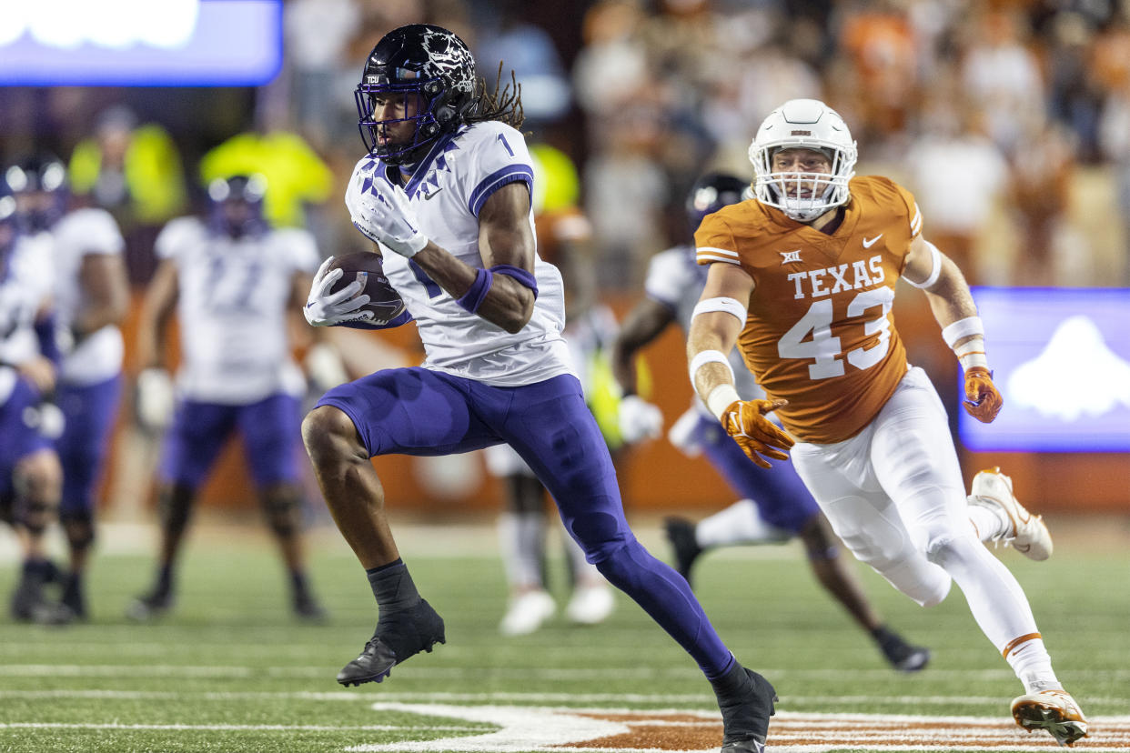 TCU wide receiver Quentin Johnston (1) runs past Texas linebacker Jett Bush (43) on Saturday, Nov. 12, 2022, in Austin, Texas. (AP Photo/Stephen Spillman)