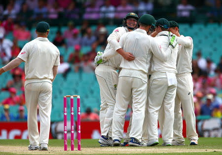 Cricket - Australia v Pakistan - Third Test cricket match - Sydney Cricket Ground, Sydney, Australia - 5/1/17 Australia's Hilton Cartwright is surrounded by team mates as he checks where he was hit by the ball from a shot by Pakistan's Younis Khan. REUTERS/David Gray