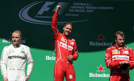 Formula One F1 - Brazilian Grand Prix 2017 - Sao Paulo, Brazil - November 12, 2017 Ferrari's Sebastian Vettel celebrates winning the race on the podium REUTERS/Ueslei Marcelino