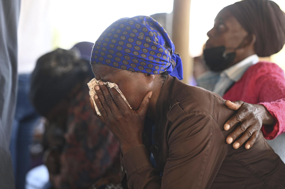 Family members of the bus crash victims gather at the ZCC Church, where victims used for church services in the Molepolole village near Gaborone, Botswana, Friday, March 29, 2024. A bus carrying Easter pilgrims from Botswana to Moria in South Africa crashed en route in Mokopane, South Africa, claiming the lives of some 45 people. An 8-year-old survived. (AP Photo)