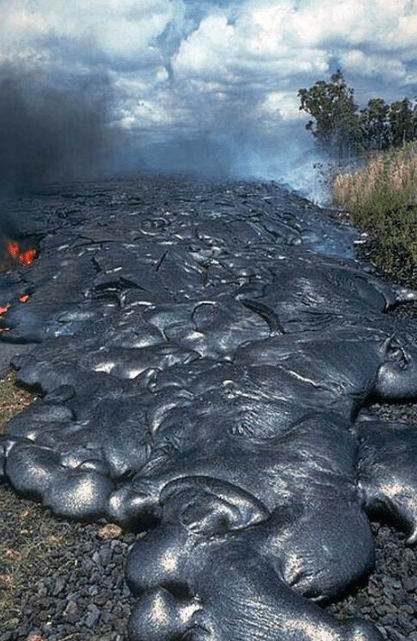 A pahoehoe flow from the Kilauea Volcano encounters a road in Hawaii. Image credit: USGS