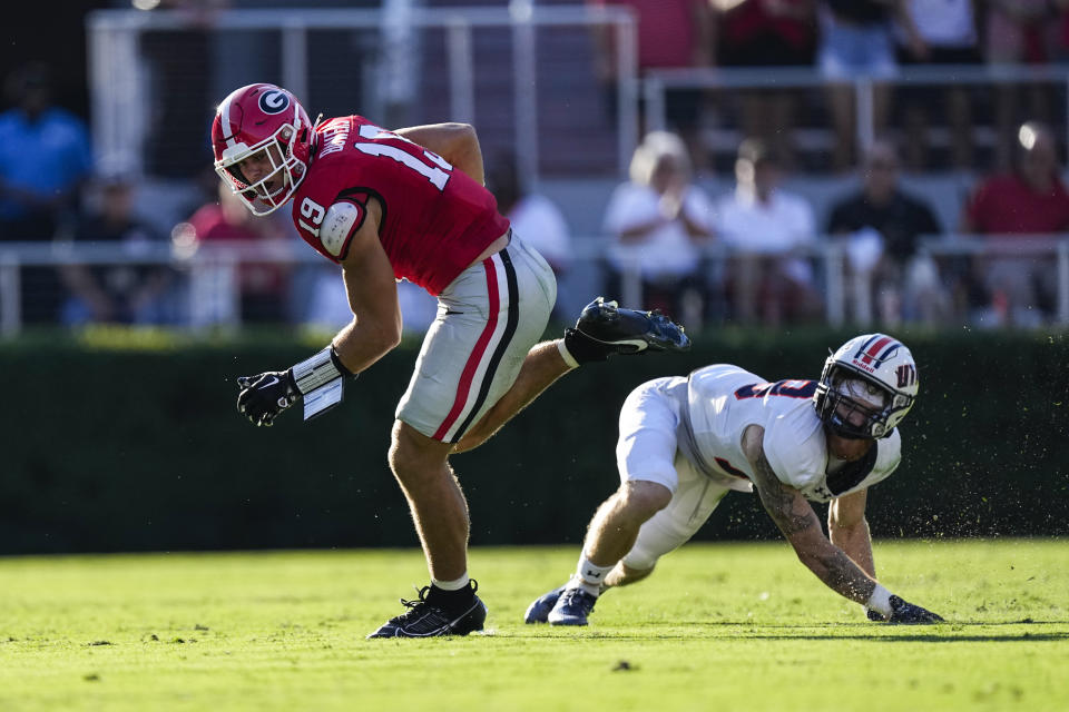 Georgia tight end Brock Bowers (19) gets past Tennessee-Martin safety Jack Lucas (19) after a catch during the first half of an NCAA college football game Saturday, Sept. 2, 2023, in Athens, Ga. (AP Photo/John Bazemore)