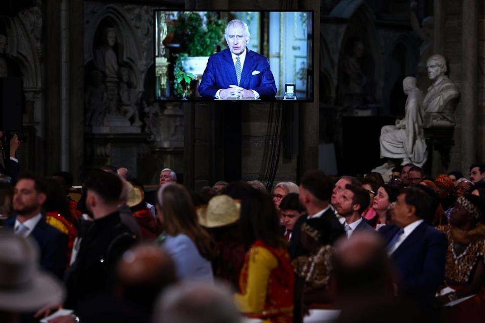 Guests watch a video of King Charles delivering a message during the annual Commonwealth Day Service at Westminster Abbey in London on Monday (Henry Nicholls/PA Wire)