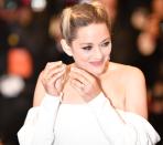 <p>She appeared to be having a little trouble with her statement gold earrings though. Photo: Getty </p>