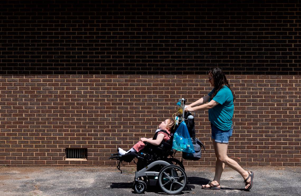 Jennifer Emerson walks with her daughter, Evangeline, 8, outside their home in Raleigh, N.C. on Thursday, July 13, 2023. Emerson and her husband bought the home using Ownify, a fractional homeownership program.