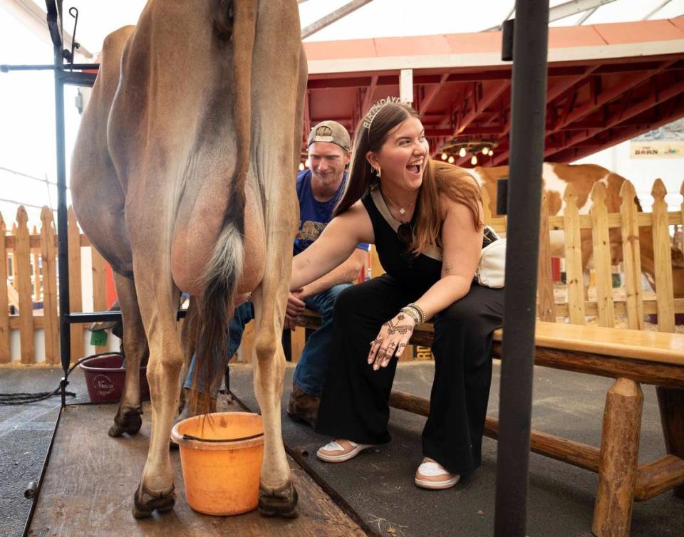 Ashley Quintana, 23, milks a cow for her birthday during the Youth Fair opening day on Thursday, March 14, 2024, at the Miami-Dade Fair and Exposition.