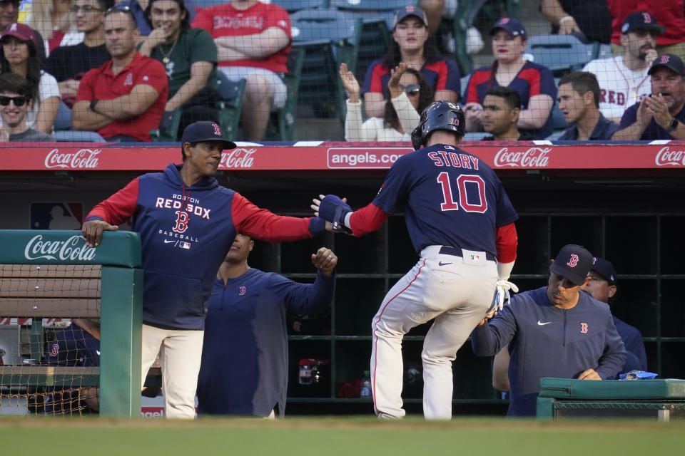 Boston Red Sox's Trevor Story (10) returns to the dugout after scoring during the second inning of a baseball game against the Los Angeles Angels in Anaheim, Calif., Tuesday, June 7, 2022. (AP Photo/Ashley Landis)