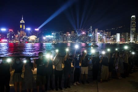 Protesters hold hands to form a human chain at the Avenue of Stars in Hong Kong