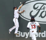 Atlanta Braves center fielder Ender Inciarte just misses a double off the wall by Toronto Blue Jays' Cavan Biggio with right fielder Ronald Acuña watching during the first inning of a baseball game Wednesday, Aug. 5, 2020, in Atlanta. (Curtis Compton/Atlanta Journal-Constitution via AP)