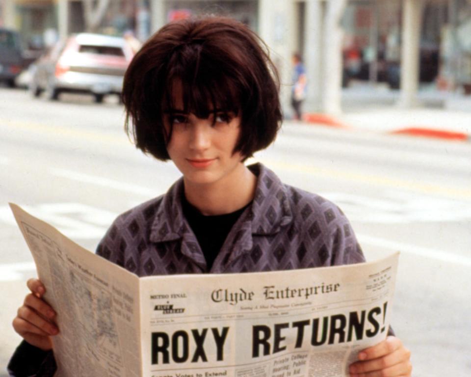close up of winona's character reading a newspaper