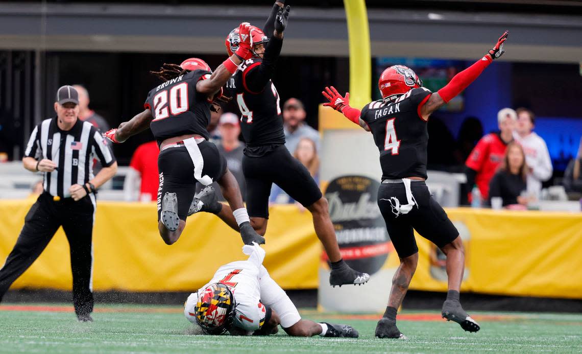 N.C. State’s Sean Brown (20), Derrek Pitts Jr. (24) and Cyrus Fagan (4) celebrate after Maryland wide receiver Dontay Demus Jr. (7) couldn’t make the reception during the first half of N.C. State’s game against Maryland in the Duke’s Mayo Bowl at Bank of America Stadium in Charlotte, N.C., Friday, Dec. 30, 2022.