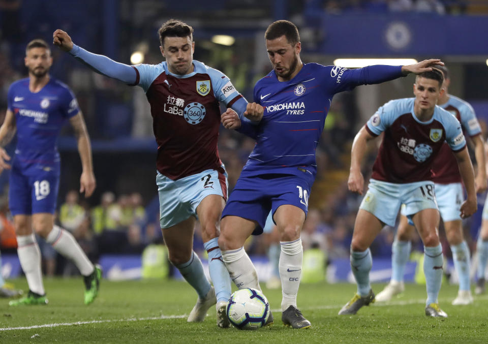 Chelsea's Eden Hazard, right, competes for the ball with Burnley's Matthew Lowton during the English Premier League soccer match between Chelsea and Burnley at Stamford Bridge stadium in London, Monday, April 22, 2019. (AP Photo/Kirsty Wigglesworth)