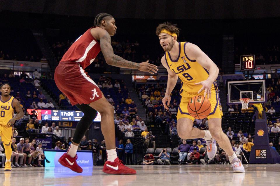 Feb 10, 2024; Baton Rouge, Louisiana, USA; LSU Tigers forward Will Baker (9) dribbles the ball against Alabama Crimson Tide forward Nick Pringle (23) during the first half at Pete Maravich Assembly Center. Mandatory Credit: Stephen Lew-USA TODAY Sports