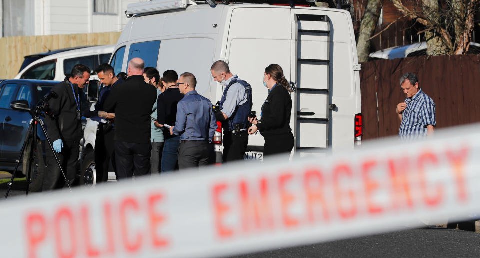 New Zealand police investigators work at a scene in Manuwera Auckland on Aug. 11, 2022