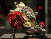 This Feb. 11, 2013 photo shows a shoe decorated with a miniature tea set and a lock titled "Alice," and designed by Nicholas Kirkwood, on display at the "Shoe Obsession" exhibit at The Museum at the Fashion Institute of Technology Museum in New York. The exhibition, showing off 153 specimens, runs through April 13. (AP Photo/Kathy Willens)