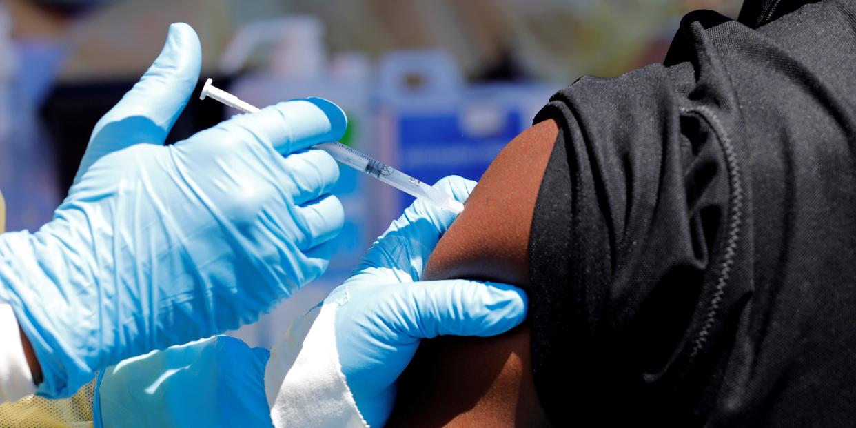 FILE PHOTO: A health worker injects a man with Ebola vaccine in Goma, Democratic Republic of Congo, August 5, 2019. REUTERS/Baz Ratner/File Photo