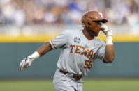 Texas' Cam Williams (55) signals his teammates as he rounds the bases after hitting a two-run home run in the second inning against Mississippi State during a baseball game in the College World Series, Saturday, June 26, 2021, at TD Ameritrade Park in Omaha, Neb. (AP Photo/Rebecca S. Gratz)