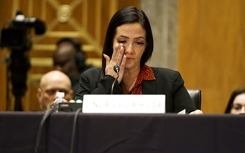 Linda De La Rosa tears up as she testifies about her experience being incarcerated in a Federal Bureau of Prisons faculty in Lexington, Ky., during a Senate Permanent Subcommittee on Investigations hearing to discuss an eight-month investigation into sexual abuse of women in federal prisons on Dec. 13. <em>Greg Nash</em>