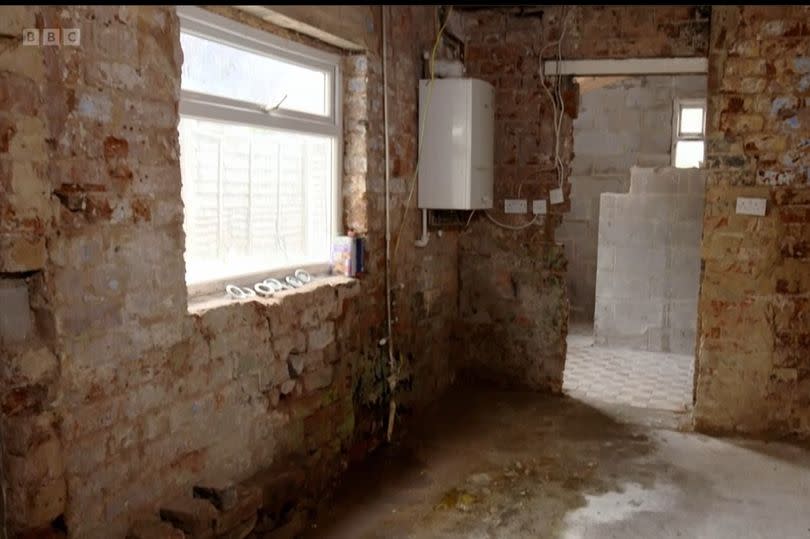 The stripped back kitchen in this mid-terrace in Bucknall