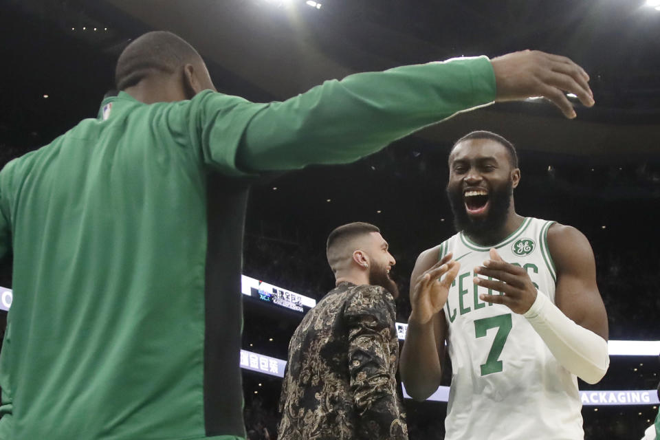 Boston Celtics guard Jaylen Brown (7) celebrates with teammate Kemba Walker in the second half of an NBA basketball game against the Detroit Pistons, Friday, Dec. 20, 2019, in Boston. (AP Photo/Elise Amendola)