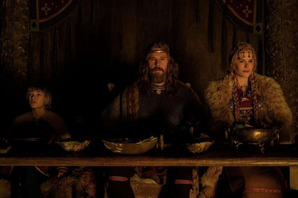 Young Amleth (Oscar Novak) attends a feast hosted by his parents, King Aurvandil (Ethan Hawke) and Queen Gudrún (Nicole Kidman), in "The Northman."