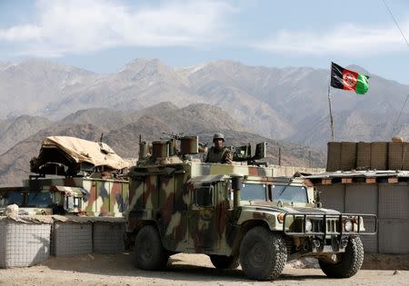 An Afghan National Army (ANA) soldier keeps watch on the back of a Humvee at a check post in Logar province, Afghanistan February 16, 2016. REUTERS/Omar Sobhani