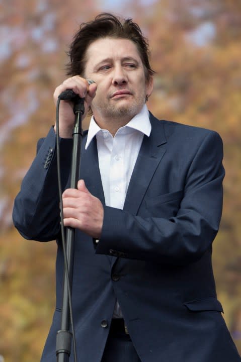 FILE – Shane MacGowan lead singer of The Pogues as the band performs at the Barclaycard British Summer Time Festival in Hyde Park, London, July 5, 2014. Macgowan, the singer-songwriter and frontman of The Pogues, best known for their ballad “Fairytale of New York,” has died. He was 65. His family said in a statement that “it is with the deepest sorrow and heaviest of hearts that we announce the passing of our most beautiful, darling and dearly beloved Shane Macgowan.” The singer died peacefully early Thursday, Nov. 30, 2023 with his family by his side, the statement added. (Laura Lean/PA via AP)