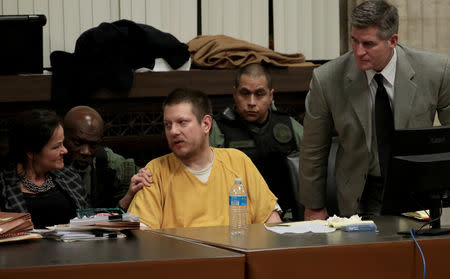 Former Chicago police Officer Jason Van Dyke reacts with attorneys Tammy Wendt and Daniel Herbert during his sentencing hearing at the Leighton Criminal Court Building in Chicago, Illinois, U.S., January 18, 2019. Antonio Perez/Chicago Tribune/Pool via REUTERS/Files