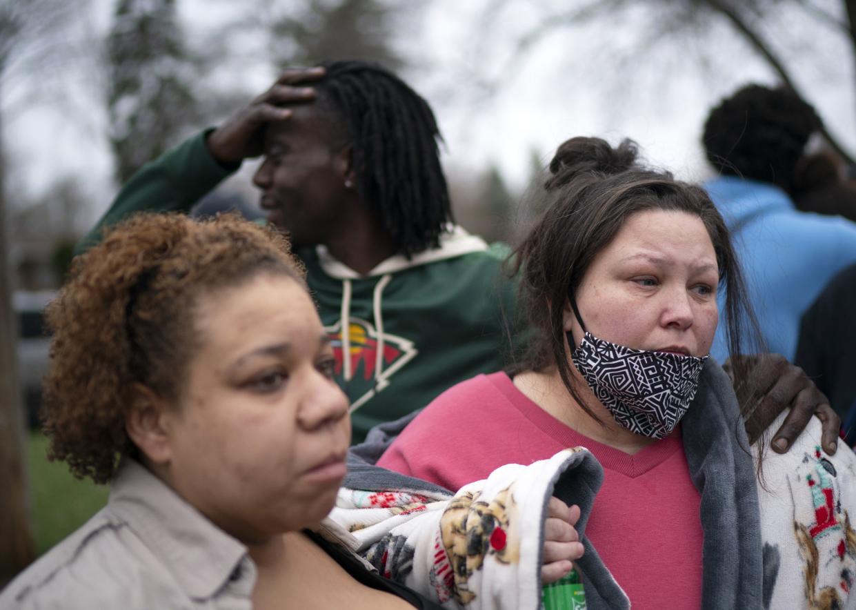 Friends and family comfort Katie Wright (right), while she speaks briefly to news media near where the family says her son Daunte Wright, 20, was shot and killed by police Sunday, April 11, 2021, in Brooklyn Center, Minn.