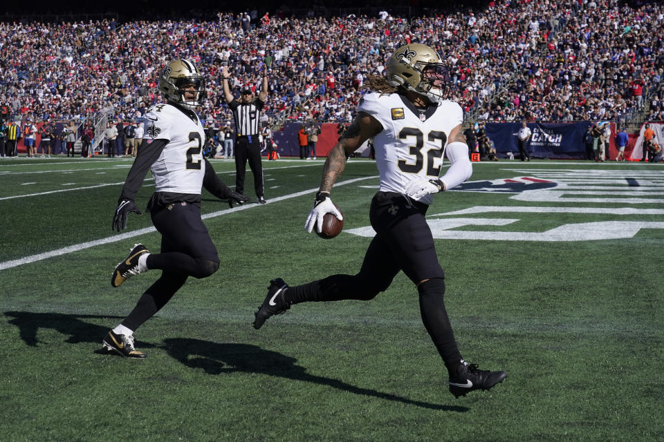 New Orleans Saints safety Tyrann Mathieu (32) is followed by safety Johnathan Abram, left, as he runs into the end zone for a touchdown after intercepting a pass by New England Patriots quarterback Mac Jones, during the first half of an NFL football game, Sunday, Oct. 8, 2023, in Foxborough, Mass. (AP Photo/Charles Krupa)