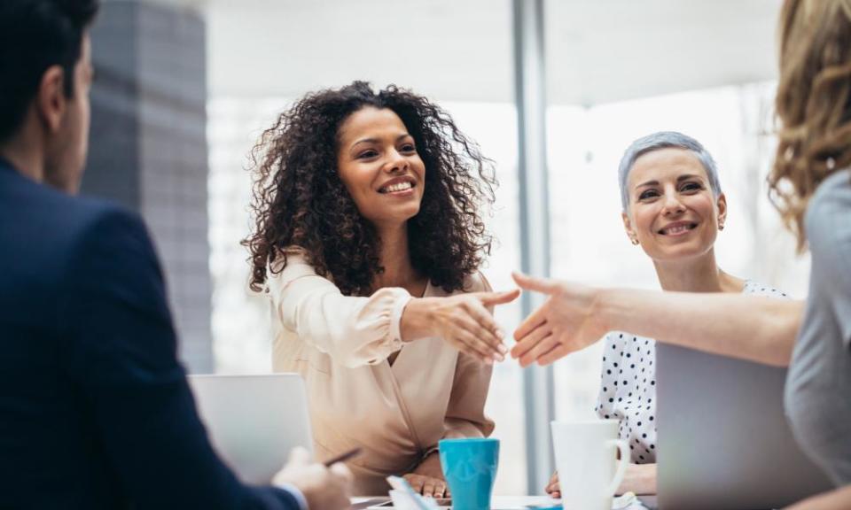 Businesswomen shaking hands at the office