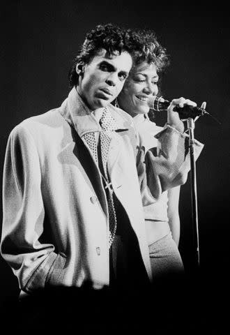 <p>Gary Gershoff/Getty </p> Prince and Sheila E. perform in New York City in August 1986