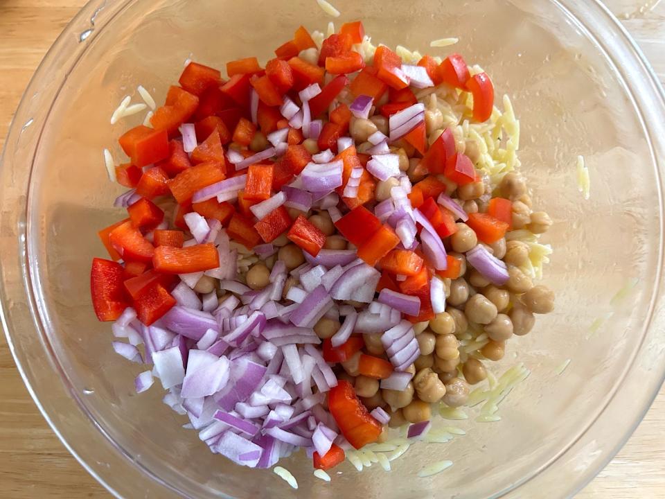 Adding the veggies to Ina Garten's Greek Orzo Salad