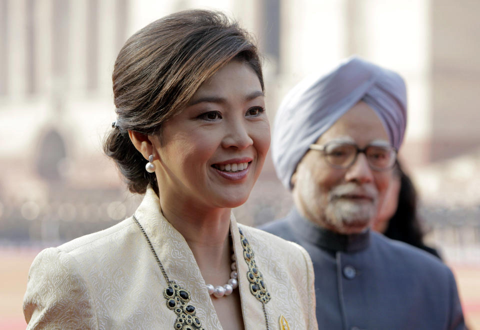 FILE - In this Jan. 25, 2012 file photo, Thai Prime Minister Yingluck Shinawatra talks to the media with Indian Prime Minister Manmohan Singh, right, during a ceremonial reception at the Presidential Palace in New Delhi, India. As she marks a year in office this weekend as Thailand's first female prime minister, Yingluck's biggest boast could be about what hasn't happened during that time: a return to the chaos that has wracked the country for much of the past six years. (AP Photo/Gurinder Osan, File)