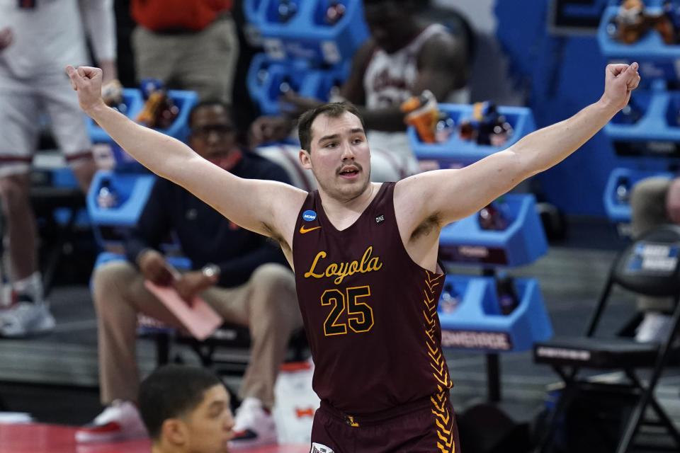 FILE - Loyola Chicago center Cameron Krutwig (25) reacts to a basket against the Illinois during the second half of a men's college basketball game in the second round of the NCAA tournament at Bankers Life Fieldhouse in Indianapolis, Sunday, March 21, 2021. College basketball is undergoing a shift, a new era ushered in by the transfer portal, NIL and conference realignment. The Ramblers had to go back to 1984-85 for their last ranking before returning at No. 22 on Feb. 8, 2021. (AP Photo/Paul Sancya, File)