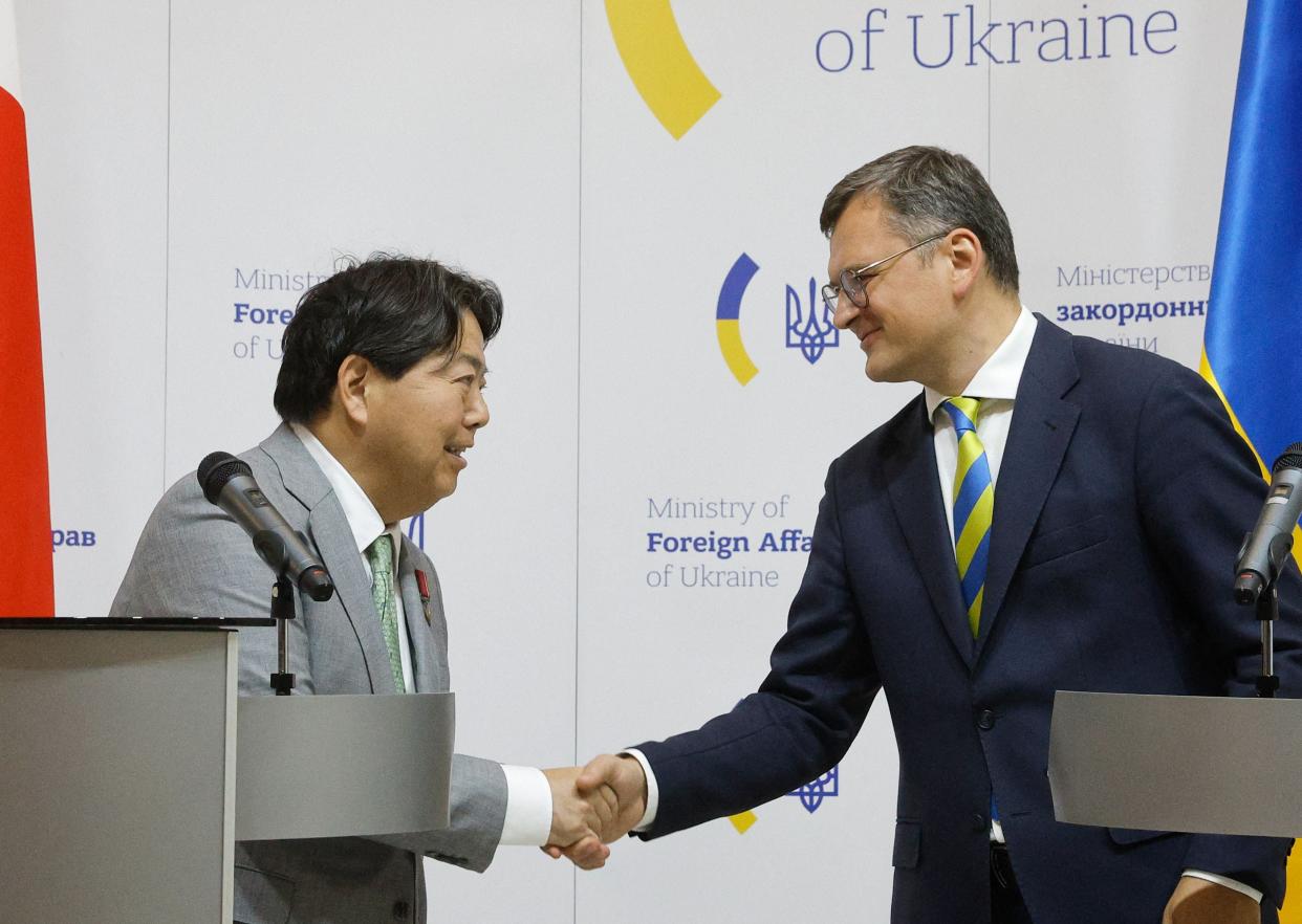 Japan’s Foreign Minister Yoshimasa Hayashi (L) shakes hands with his Ukrainian counterpart Dmytro Kuleba during a joint press conference in Kyiv. (POOL/AFP via Getty Images)