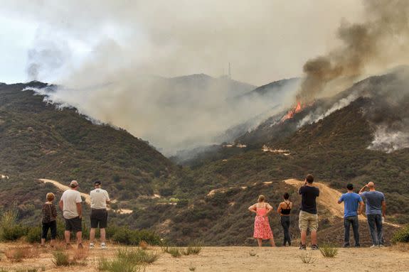 People watch the La Tuna Fire burning in the Verdugo Mountains on September 2, 2017. Hundreds of firefighters battled the blaze overnight and into the morning, and at one point the flames were spreading in four directions at once amid intense heat and wild winds.