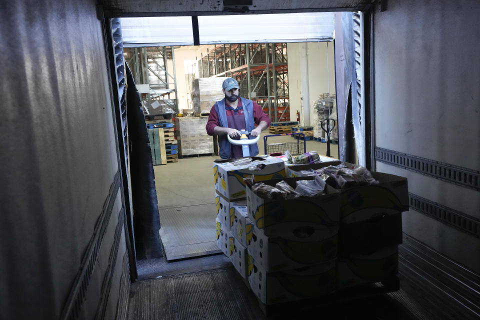 Driver Jake Czamanski loads recovered food onto a truck, to be distributed at a mobile food bank, at Feeding Westchester in Elmsford, N.Y., Wednesday, Nov. 15, 2023. A growing number of states are working to keep food out of landfills over concerns that it is taking up too much space and posing environmental problems. Some states including New York are requiring supermarkets and other businesses to redirect food to food pantries. (AP Photo/Seth Wenig)