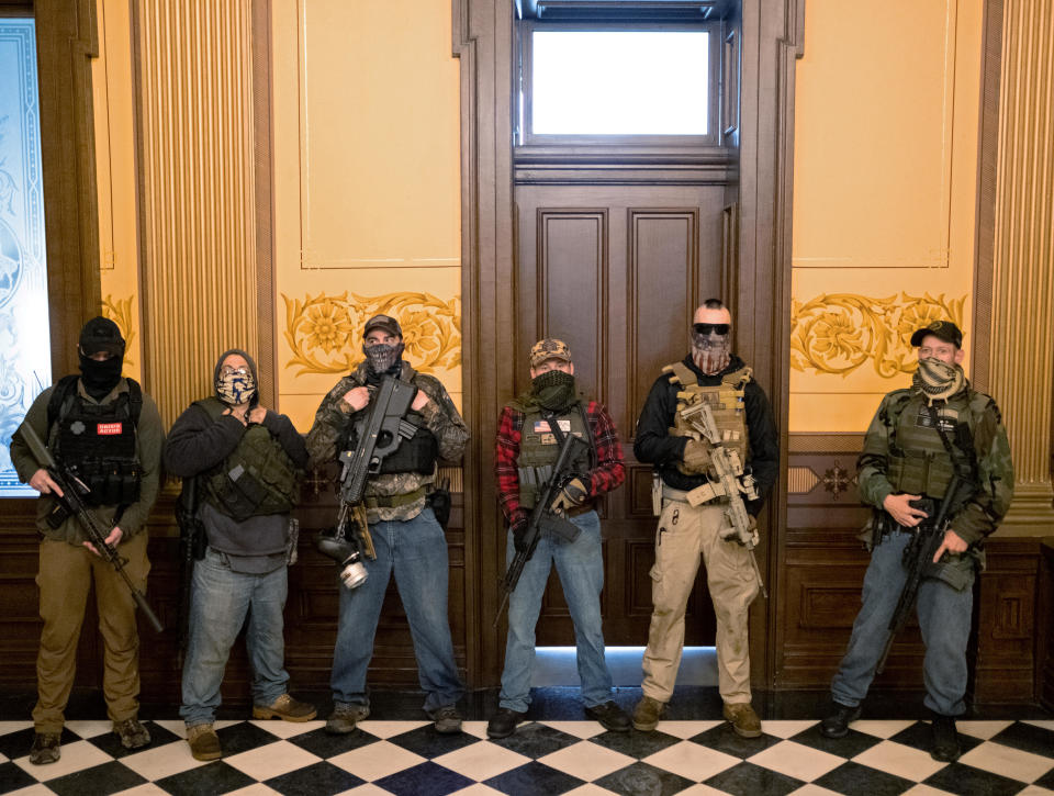 A militia group with no political affiliation from Michigan stands in front of the Governors office after protesters occupied the state capitol building during a vote to approve the extension of Governor Gretchen Whitmer's emergency declaration/stay-at-home order due to the coronavirus outbreak, at the state capitol in Lansing, Michigan, on April 30, 2020. / Credit: SETH HERALD / REUTERS