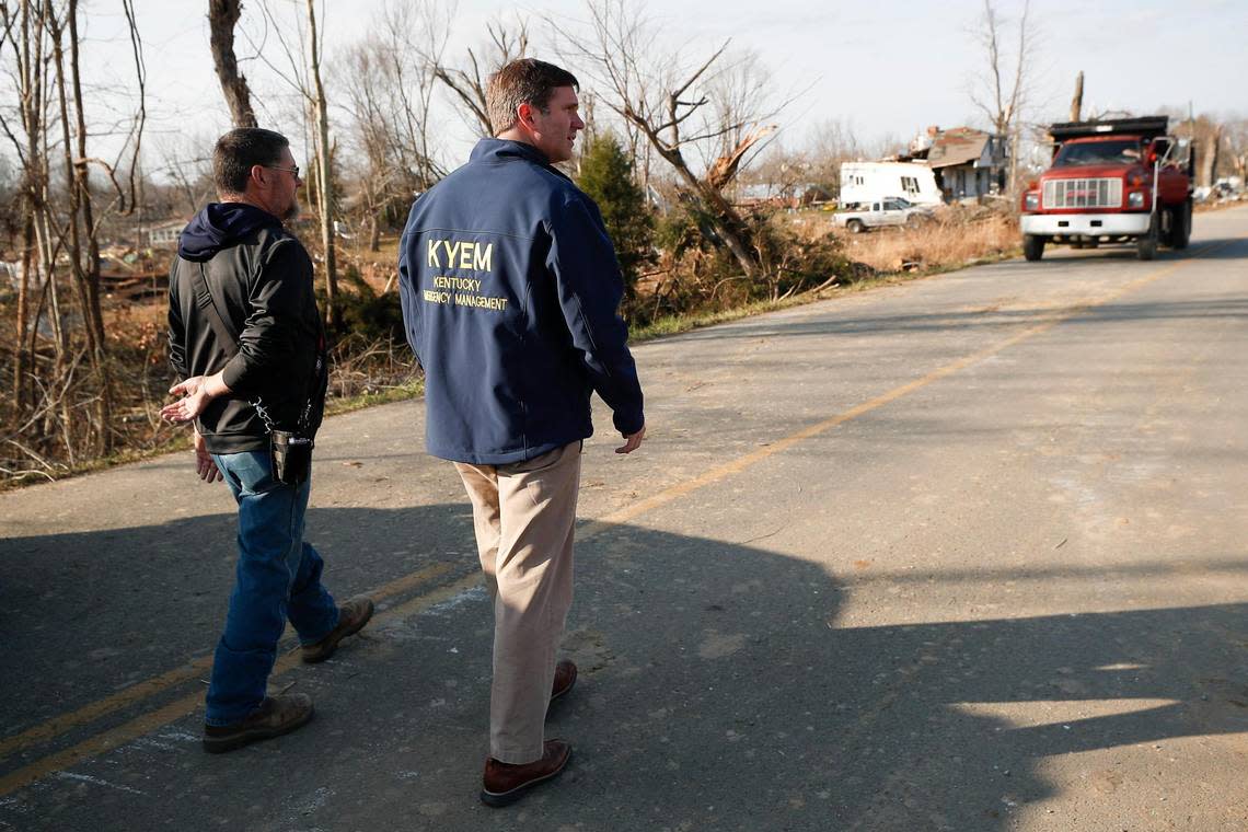 Bremen Mayor Allen Miller, left, leads Kentucky Gov. Andy Beshear through a tornado ravaged area of Bremen, Ky., Tuesday, Dec. 14, 2021.