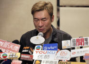 Hong Kong singer Andy Hui reacts during a press conference about his affair in Hong Kong, Tuesday, April 16, 2019. Hong Kong's Apple Daily newspaper published video that purported to show Andy Hui being intimate in a taxi with another Hong actress, decades younger than him, Jacqueline Wong. (AP Photo/Vincent Yu)