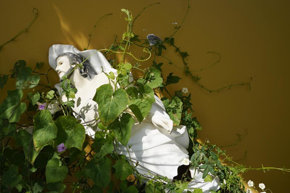 A religious image hangs next to bullet holes in a home abandoned in El Limoncito in the Michoacan state of Mexico, Saturday, Oct. 30, 2021. "The most shameful thing is the absence of the government, which has become simply a spectator in a war that has left so many dead, so much destruction," said the local priest in Aguililla, the Rev. Gilberto Vergara, describing the residents' frustration with army's reluctance to fight either of the two cartels. (AP Photo/Eduardo Verdugo)