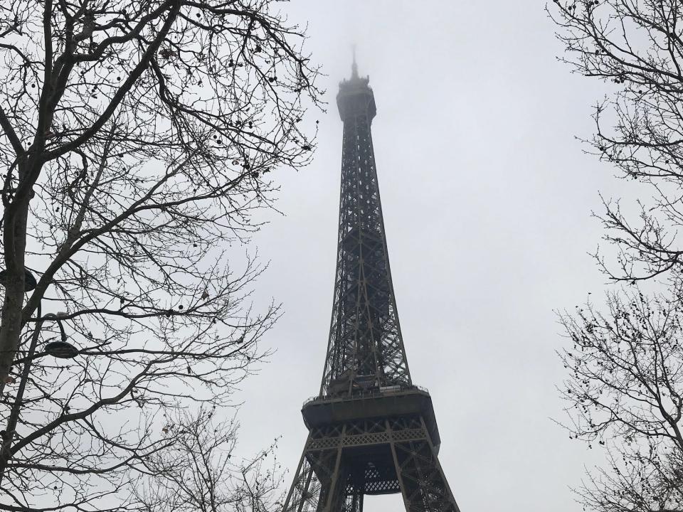 shot of the eiffel tower in paris on a gray, cloudy day