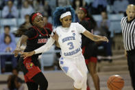 Louisville guard Dana Evans, left, and North Carolina guard Madinah Muhammad (3) chase the ball during the second half of an NCAA college basketball game in Chapel Hill, N.C., Sunday, Jan. 19, 2020. (AP Photo/Gerry Broome)