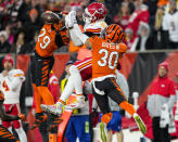 Cincinnati Bengals cornerback Cam Taylor-Britt (29) and safety Jessie Bates III (30) break up a pass intended for Kansas City Chiefs wide receiver JuJu Smith-Schuster (9) in the first half of an NFL football game in Cincinnati, Sunday, Dec. 4, 2022. (AP Photo/Jeff Dean)