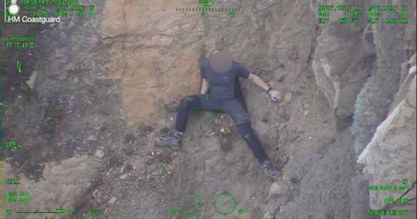 一名男子徒手攀爬峭壁，結果卡在山壁上動彈不得。（圖／翻攝自Maritime and Coastguard Agency臉書）