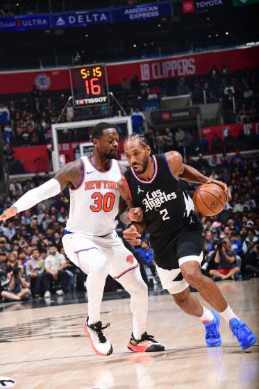 Clippers star Kawhi Leonard, right, tries to drive past New York Knicks forward Julius Randle at Crypto.com Arena.