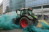 A farmer drives his tractor near the European Council building in Brussels during a demonstration of farmers, Tuesday, March 26, 2024. Dozens of tractors sealed off streets close to European Union headquarters where the 27 EU farm ministers are meeting to discuss the crisis in the sector which has led to months of demonstrations across the bloc. (AP Photo/Geert Vanden Wijngaert)